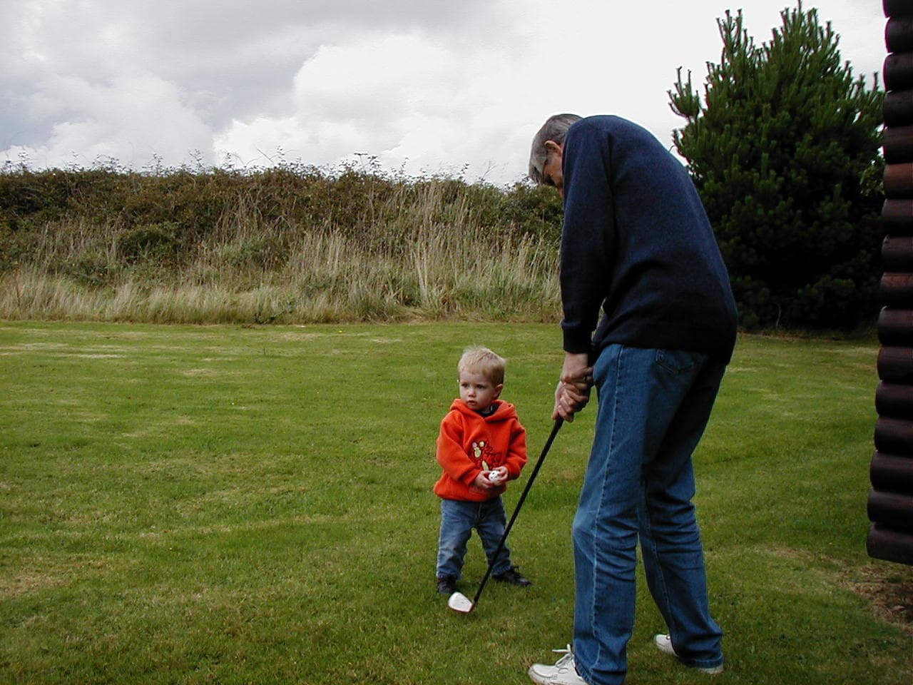 "It's never too early to learn" - David teaches Ethan the art of the perfect swing.