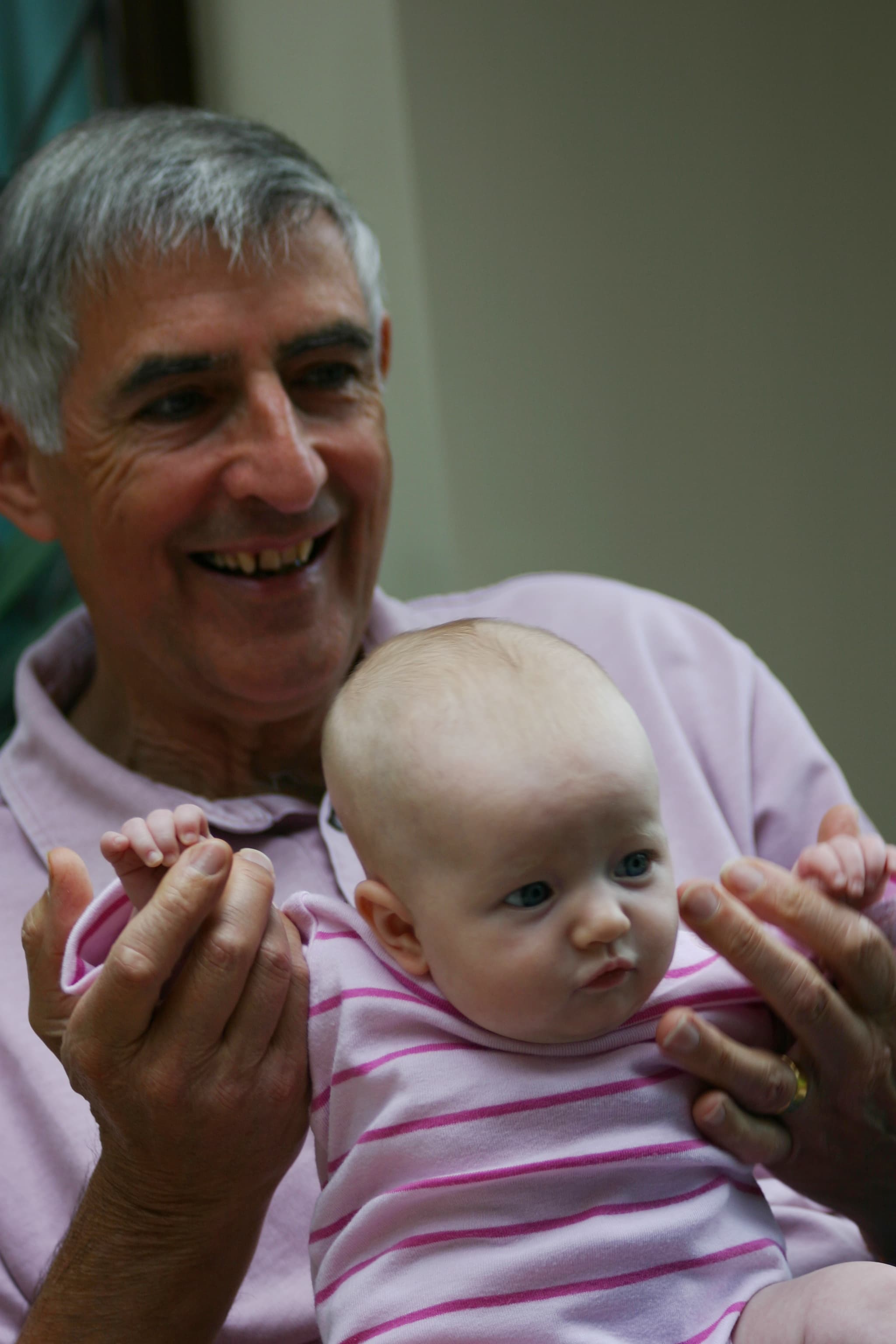 David demonstrates his natural grand parenting instincts with the latest addition to the Balston clan, Lizzie - 2009.